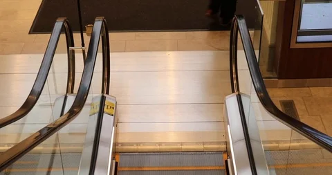Point-of-view: Slowly riding down an escalator to the bottom Stock Footage 121541411