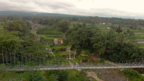 Point of view suspension bridge and waterfall cascade aerial footage Stock Footage 107173232