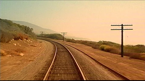 Point of view from train engine passing trees and train tracks southwestern Stock Footage 29806430