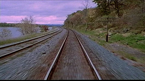 Point of view from train engine running down tracks and water on left 스톡 동영상 29806557