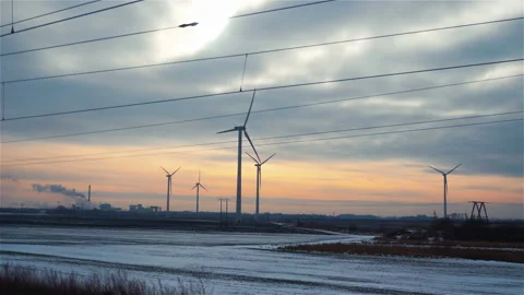 Point of view from train passing windmills at sunset in 4k slow motion Video stock 88776774
