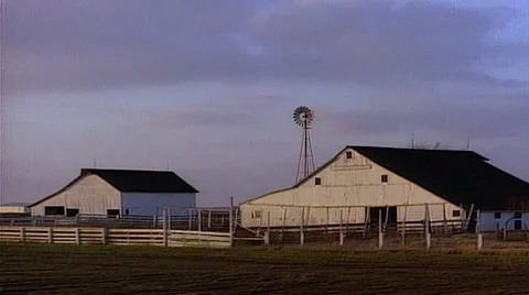 Point of view from train window tracking shot right to left of farm and windmill Stock Footage 29804063