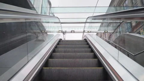 Point of view travelling up escalators out into the day light Stock Footage 242777944