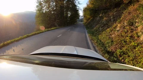 Point of view video: Car driving on a asphalt road at sunset flares Stock Footage 97119438