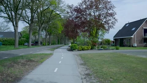 Point of view video walking on a path in a dutch suburban neighborhood 動画素材 336594685