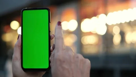 Point of View of voman at street Using Phone With Green Mock-up Screen Chroma Stock Footage