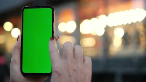 Point of View of voman at street Using Phone With Green Mock-up Screen Chroma Stock Footage 169441454