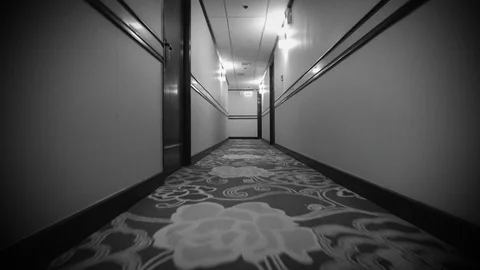 Point of View of Walking Down Ominous Hotel Corridor Passing Through Pools of Stock-Footage 123405867