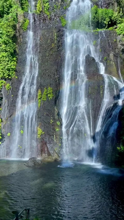Point of view walking shot revealing beautiful twin waterfall in Bali Stock Footage 336473786