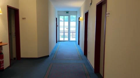 Point of view - walking through a hotel hallway. Empty Corridor in a hotel. Stock Footage 289540472