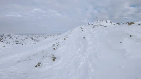 Point of view of walking to the top of a snow covered mountain in the alps Stock Footage 100053669