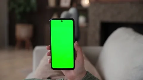 Point of view of woman lying on couch using smartphone with chroma key green Stock Footage 237514247