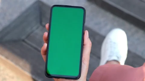 Point of View of Woman at street Using Phone With Green Mock-up Screen Chroma Ke Stock Footage 155181337