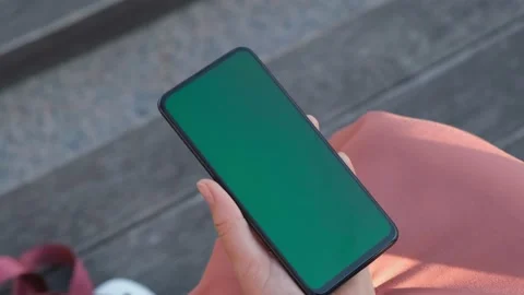 Point of View of Woman at street Using Phone With Green Mock-up Screen Chroma Ke Stock Footage 155181608