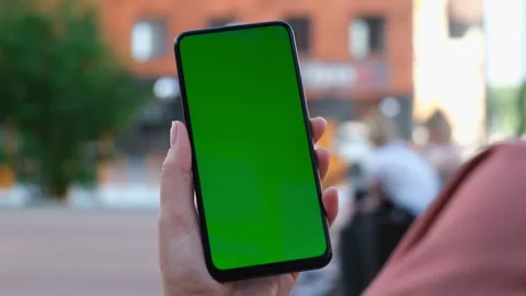 Point of View of Woman at street Using Phone With Green Mock-up Screen Chroma Ke Video stock 155181828