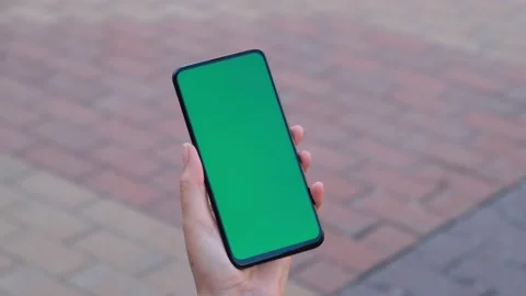 Point of View of Woman at street Using Phone With Green Mock-up Screen Chroma Ke Stock Footage 155181851