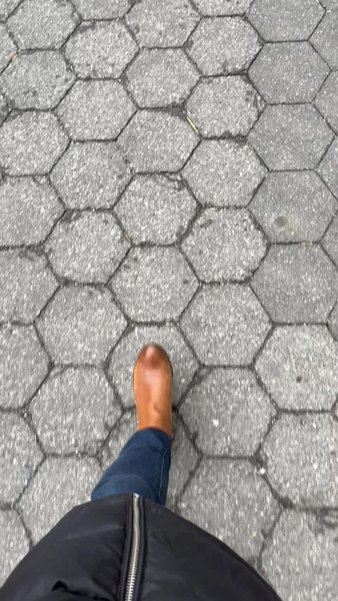 Point of View: A Woman Walking on a Paved Walkway, Vertical Video Stock Footage 305894331