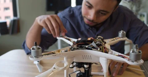 Point of view woman's hands building a drone with a man Stockbeeldmateriaal 80315482