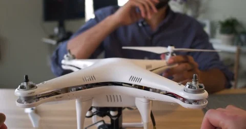 Point of View of a woman's hands putting propellers on a drone with a man Stockbeeldmateriaal 80314251
