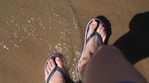 Point of view Young Man Flip Flops walking Sand Sea Beach. Slow motion Legs. Stock Footage 128525043