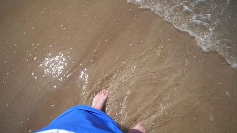 Point of view Young Man stand Beach. Male legs Ocean Sand shore Wave slow motion Stock Footage 128523993
