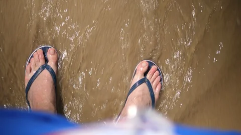 Point of view Young Man standing on Beach. Male legs with flip flops Ocean Sandy Stock Footage 128525071