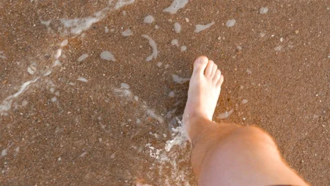 Point of view of young man stepping at the golden sand at sea beach. Stock Footage 128730515
