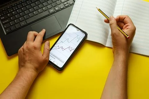 Point of view of a young man studying economics with different study stuff Stock-Fotos