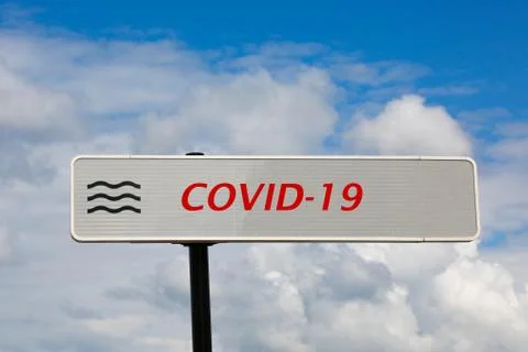 Pointer with added red text inscription Covid-19 and three black waves are ag Stock Photos