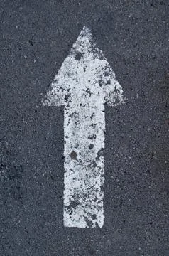 Pointer arrow on the asphalt. Stock Photos