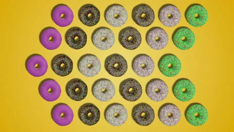 Pointer arrows made of donuts with sprinkles and icing on yellow background Stock Footage 194655243