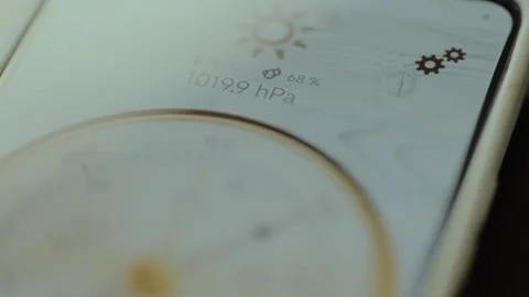 Pointer on Barometer is indicating the reading of atmospheric pressure on mobile Stock Footage 326880118