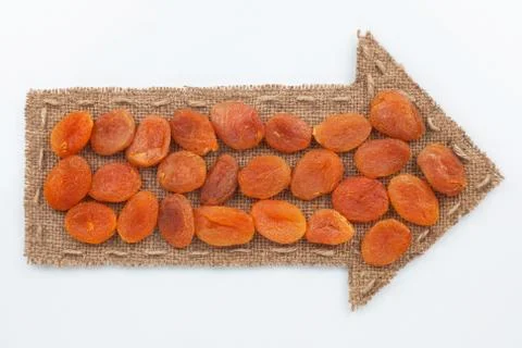 Pointer of  burlap with dried apricots Stock Photos