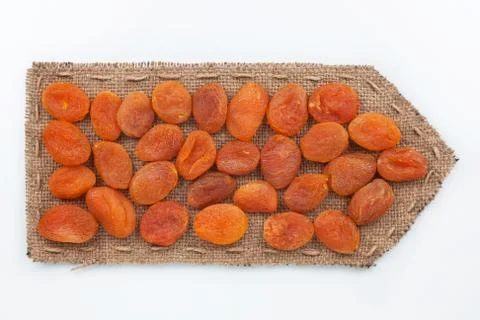 Pointer of  burlap with dried apricots Stock Photos