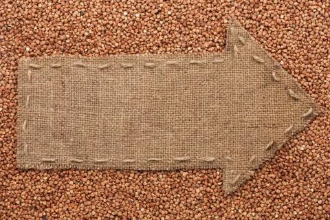 Pointer of  burlap lies on  buckwheat  grain Stock Photos