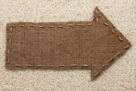 Pointer of  burlap lies on  rice  grain Stock Photos