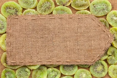 Pointer of burlap lying on a dry kiwis background Stock Photos