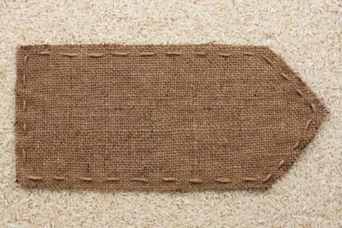 Pointer of burlap lying on a rice background Stock Photos