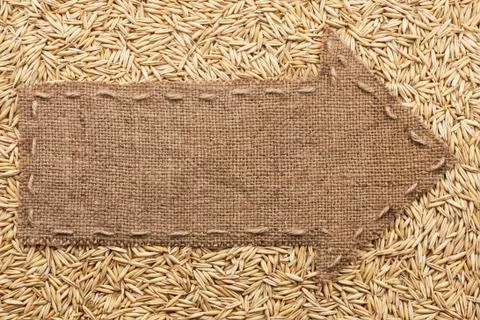 Pointer of burlap with place for your text, lying on a oat Stock Photos