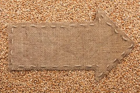 Pointer of burlap with place for your text, lying on a wheat Stock Photos
