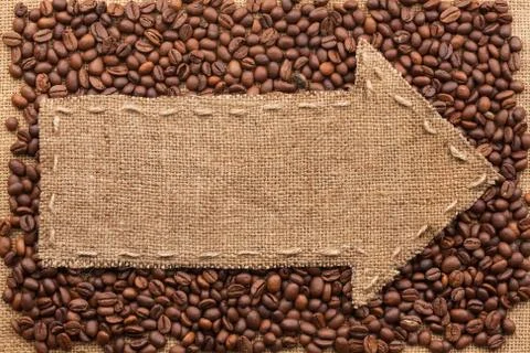 Pointer of burlap with place for your text, lying on a coffee beans Stock Photos