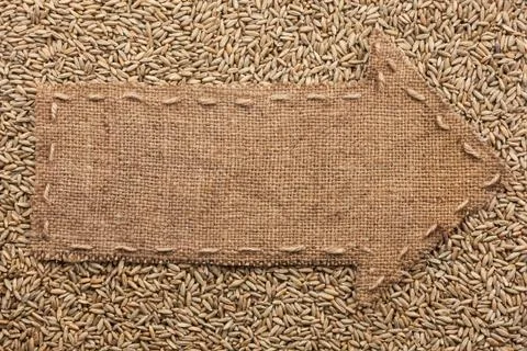 Pointer of burlap with place for your text, lying on a rye Stock Photos
