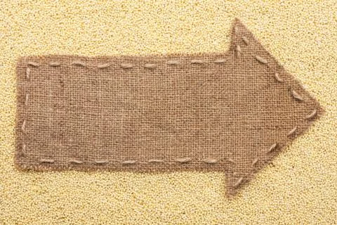 Pointer of burlap with place for your text, lying on a millet Stock Photos