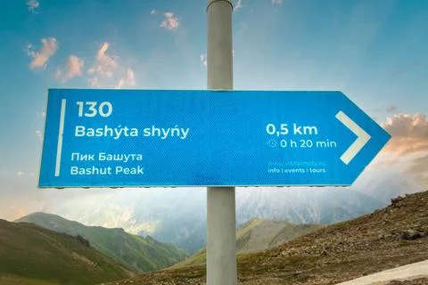 Pointer with direction, distance and time to Bashut peak in Almaty mountains of Stock Photos