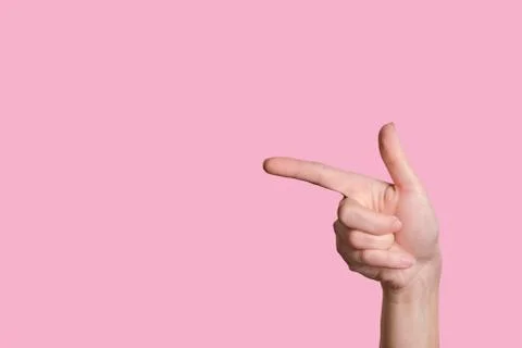 Pointer to the left. A beautiful caucasian hand indicates the direction. Stock Photos
