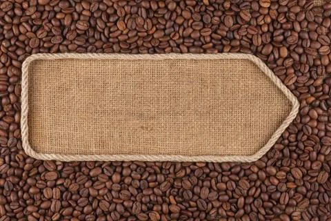 Pointer made from rope with coffee beans lying on sackcloth Stock Photos