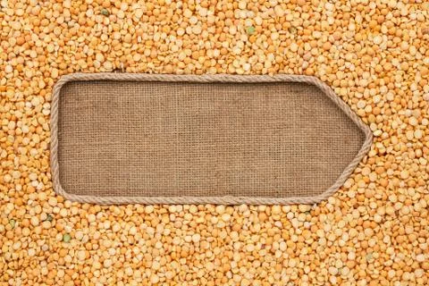 Pointer made from rope with grain peas  lying on sackcloth Stock Photos