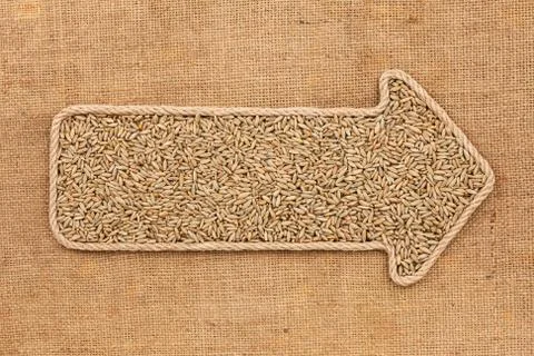 Pointer made from rope with grain rye  lying on sackcloth Stock Photos