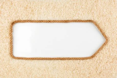 Pointer made from rope with grains rice  lying on a white background Stock Photos