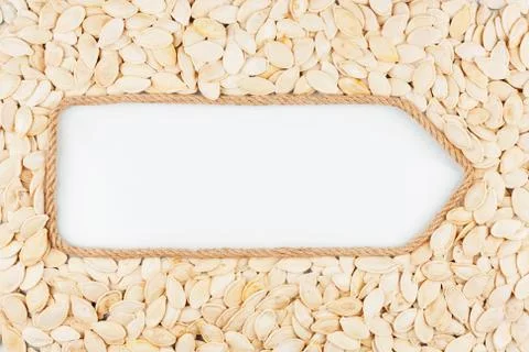 Pointer made from rope with seeds pumpkin  lying on a white background Stock Photos